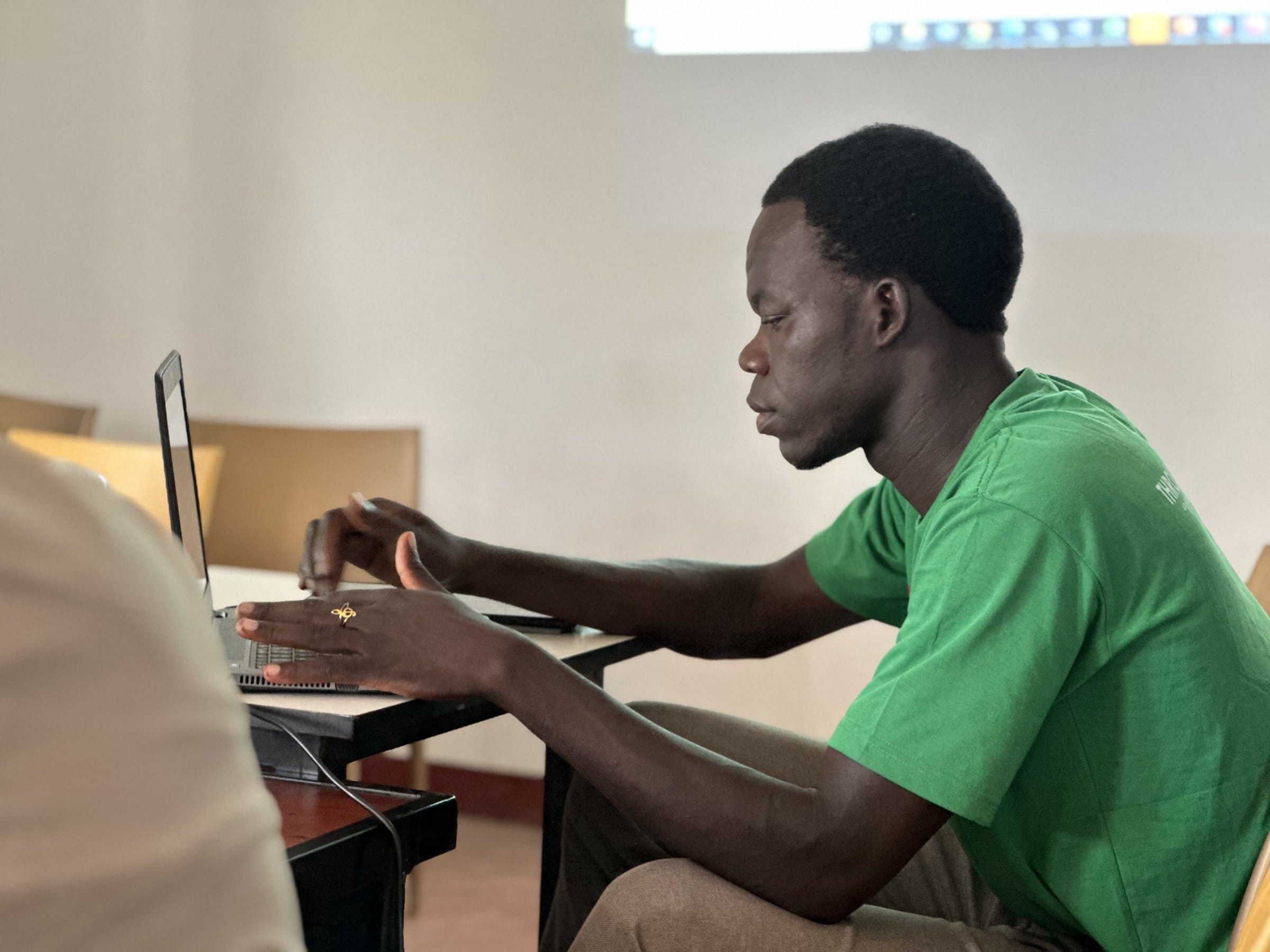 A young man works on a laptop during a training session