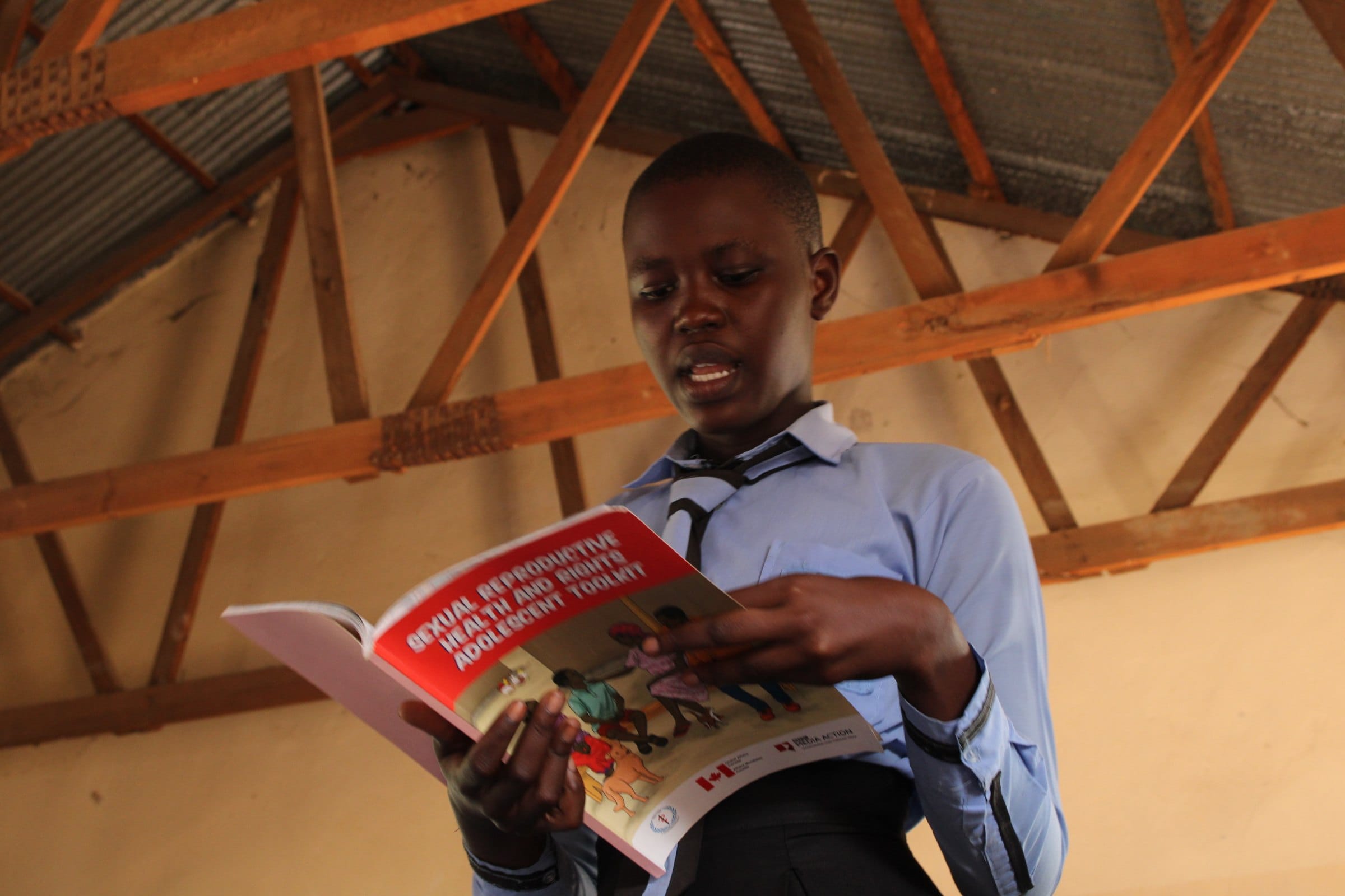 A student reads a book during a school club session