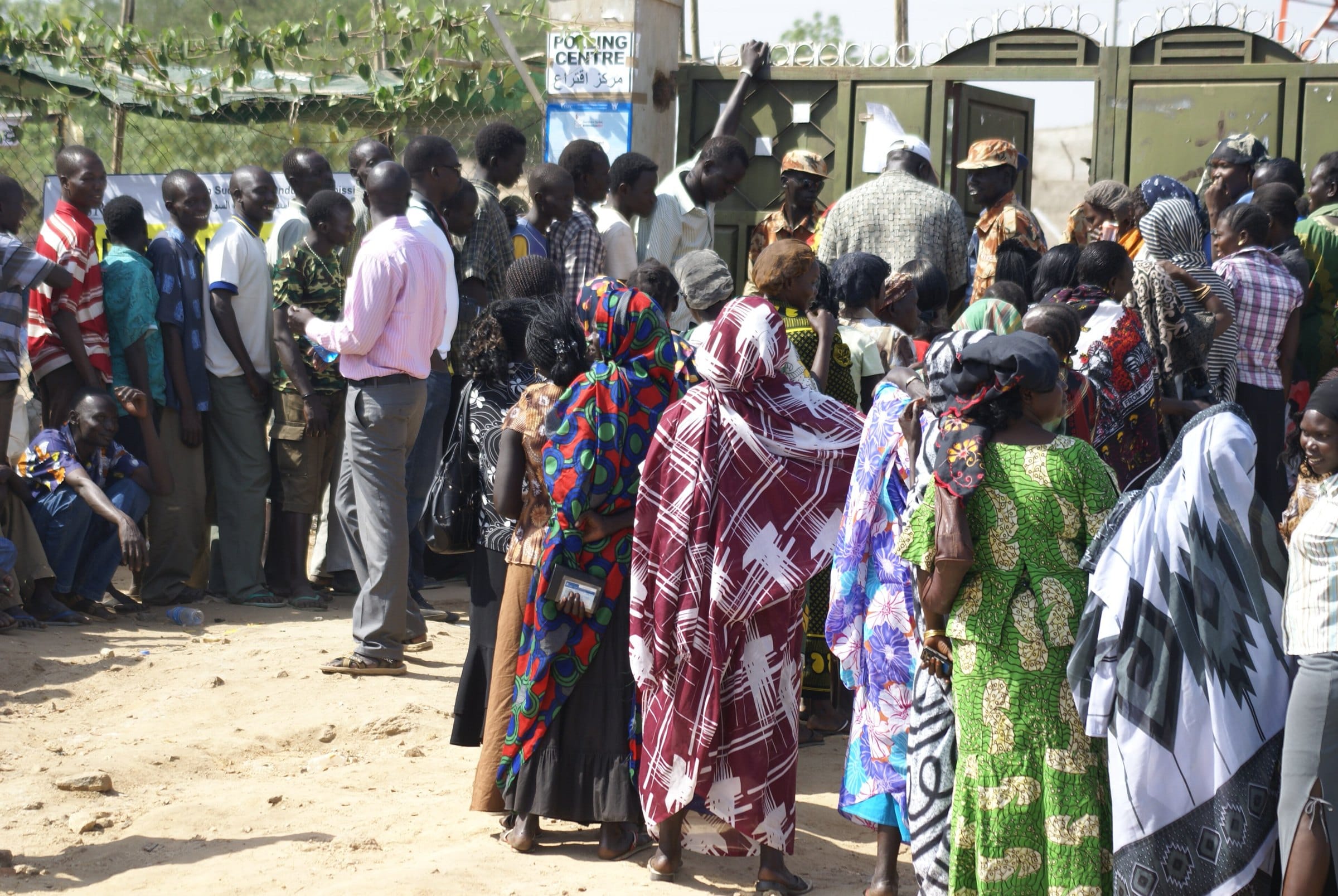 Women in bright dresses queue to vote in Juba