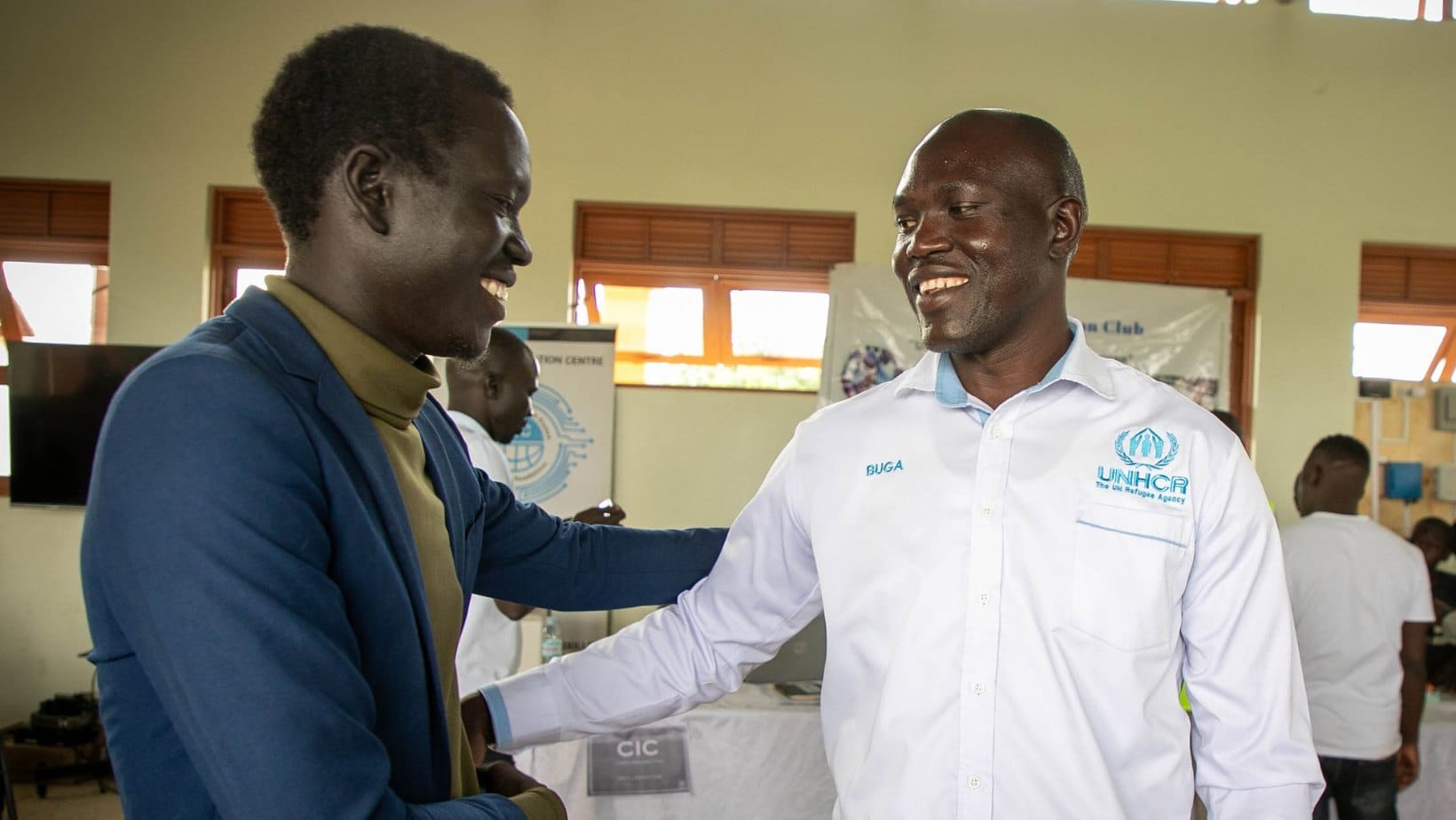 Ronald Ladu greeting a UNHCR officer at the showcase