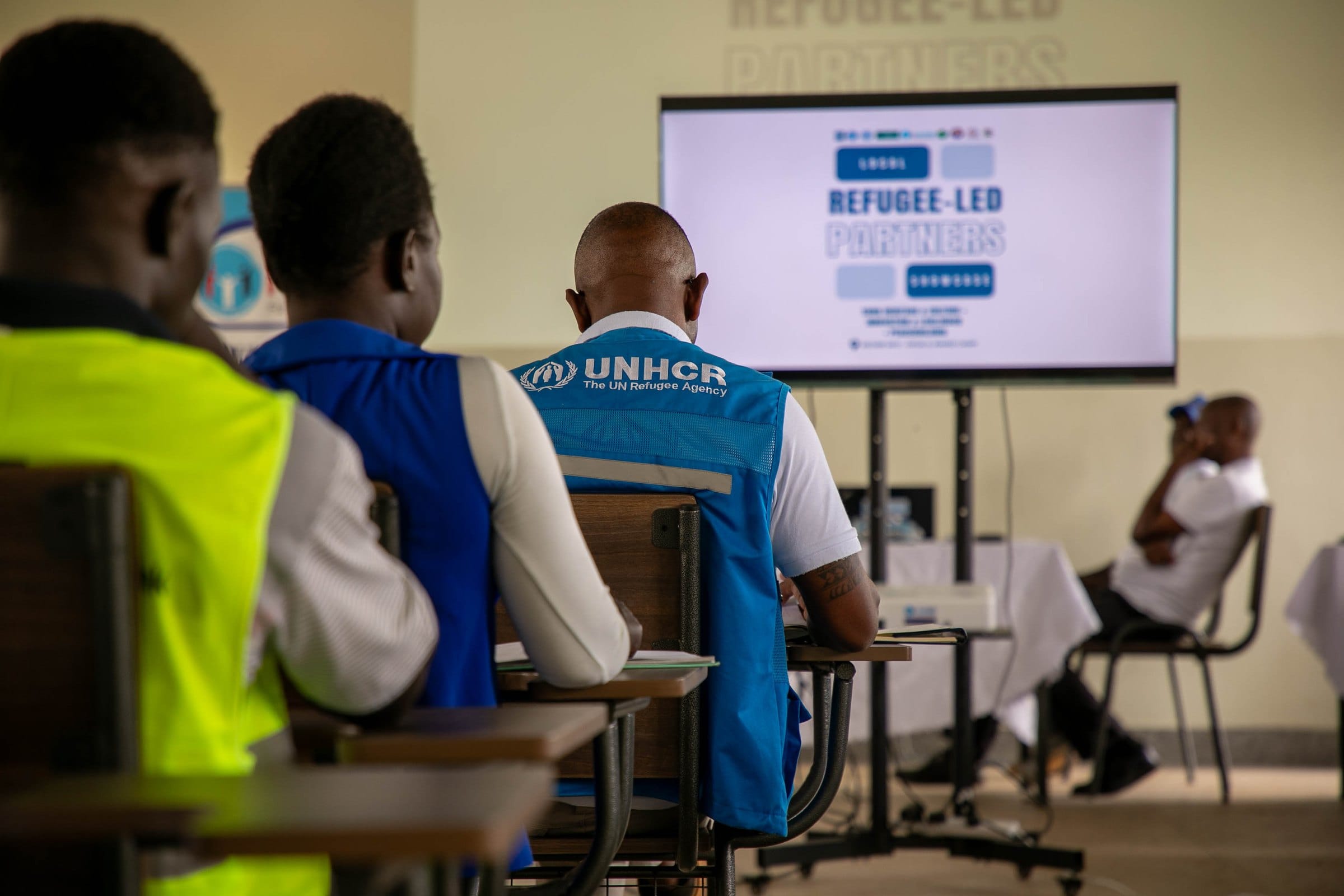 Participants, including UNHCR staff, following a presentation at the showcase